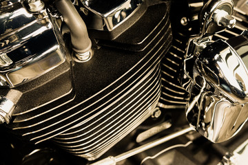 Motorcycle internal combustion engine with air cooling, close-up, detail, macro. Engine parts, cylinder head, ignition, exhaust pipe, air-intake manifold