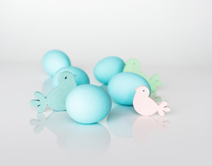 Spring and Easter holiday concept. Easter eggs painted blue and white, pastel color background. Isolated on white.
