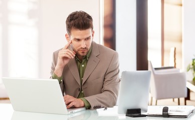 Smart businessman working at office desk