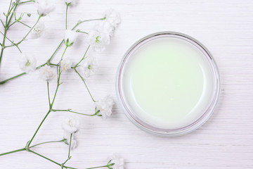 Cosmetic natural cream in a jar on a white table background.