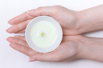 Natural cosmetic face mask in a jar on a white table background.