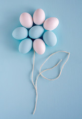 Fototapeta premium Spring and Easter holiday concept. Easter eggs painted blue and white, pastel color background. Isolated on white.