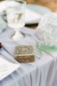 Small gold box with floral design on table
