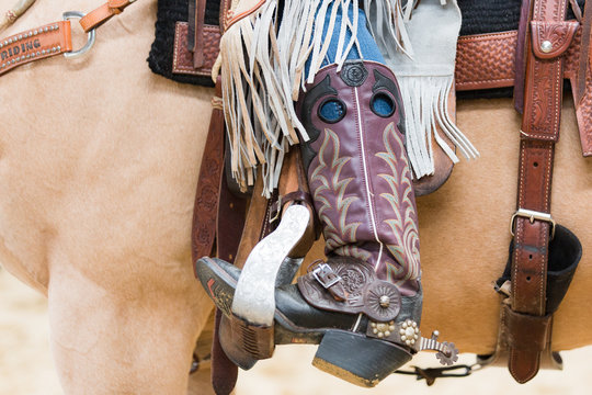 Cowboy boot of rider in saddle