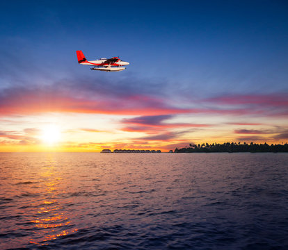 Beautiful sunset on Maldives resort with seaplane