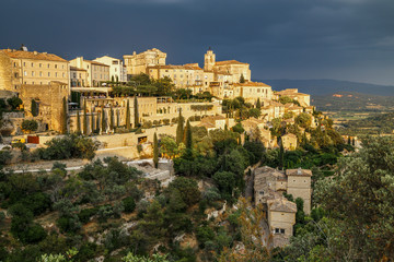 Fototapeta na wymiar Amazing panoramic view of medieval hilltop village of Gordes before thunderstorm in Provence, France. Travel France.