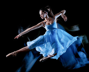 one caucasian young woman ballet dancer dancing isolated on black background with  light painting motion blur speed effect
