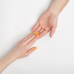 Female and male hands on a light background.