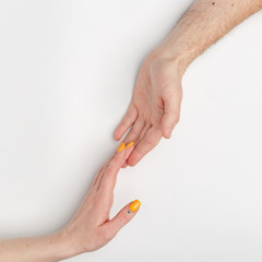 Female and male hands on a light background.
