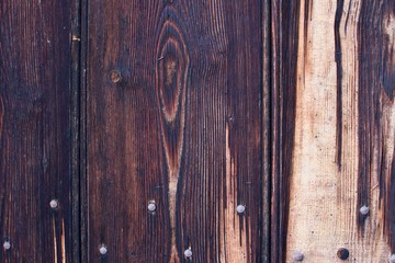 dark brown wooden structure template with iron nails on a church door