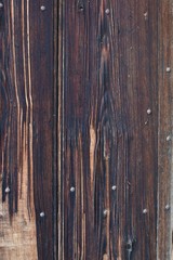 dark brown wooden structure template with iron nails on a church door