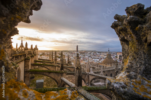 High angle view of Seville Cathedral against cityscape during sunset