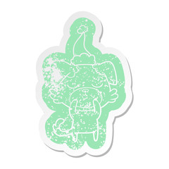 cute cartoon distressed sticker of a dog wearing santa hat