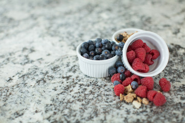 Ramekins of blueberries, raspberries and granola