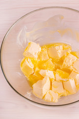 Melted butter for baking in a transparent bowl, top view, vertical