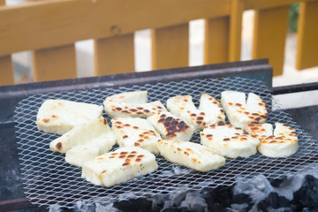 Roasted local cyprus cheese halloumi on metal baking sheet background