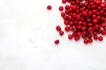 Fresh cherry on a light stone background. Concept of harvest. Flat lay, top view