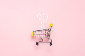 Shopping trolley from the supermarket on an isolated pink background. Shopping in the Mall, shop,...