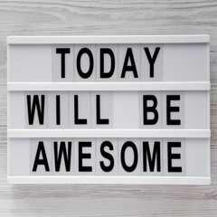 'Today will be awesome' words on lightbox over white wooden surface, top view. Overhead, flat lay, from above.