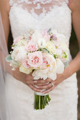 Closeup of bride holding wedding bouquet