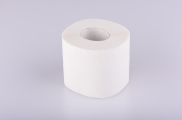 A roll of white toilet paper isolated. The paper product used in the sanitary and hygienic purposes.