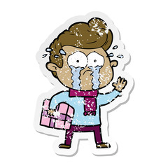 distressed sticker of a cartoon crying man with present