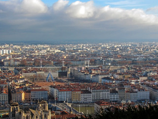 Fototapeta na wymiar Aerial view of a cityscape of downtown Lyon in France with plenty of red roofs and white old buildings
