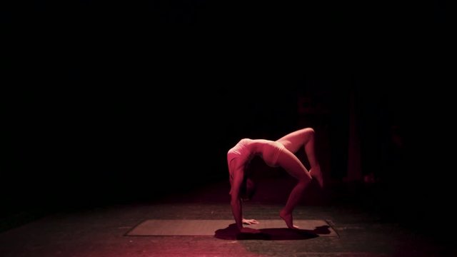 Female contortionist circus performer performing on stage