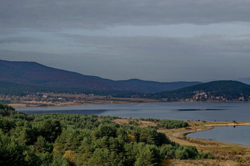Fototapeta premium Amazing autumn view holiday village around Tsigov chark resort and Batak dam reservoir, Rhodope mountains, Bulgaria 