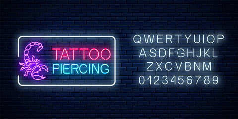 Tattoo and piercing parlor glowing neon signboard with scorpio emblem and alphabet. Tattooing salon sign © generationclash