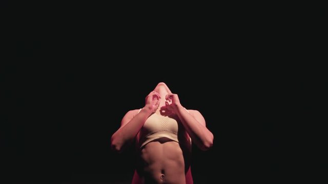 Portrait of bald woman athlete, looking towards camera & then stretching
