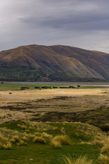 Beautiful vast valley with mountains on the horizon, brown hills, during sunny with dramatic sky