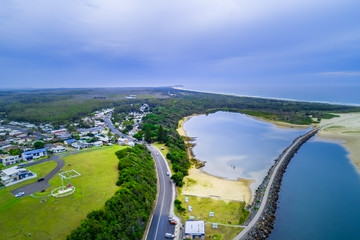 Aerial view of Harrington village, breakwater, and ocean coastline. Harrington, New South Wales,...