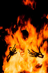 Iron demon sculpture burning in fire