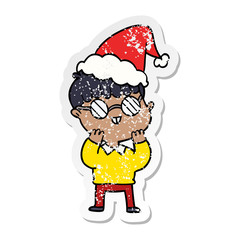 distressed sticker cartoon of a boy wearing spectacles wearing santa hat