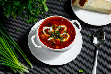 Ukrainian national dish borsch. Beet, beans, meat, potatoes with sour cream and herbs. Serve with lard and garlic or onion