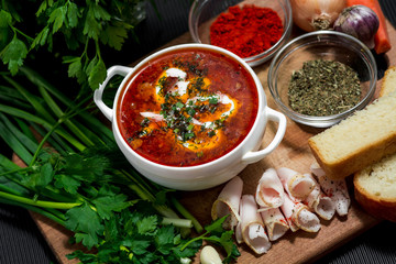 Ukrainian national dish borsch. Beet, beans, meat, potatoes with sour cream and herbs. Serve with lard and garlic or onion
