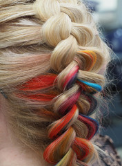 Fototapeta premium Rainbow hair in a braid. Braiding close up.