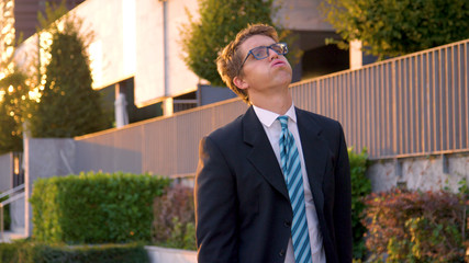 CLOSE UP: Sad businessman slumps his shoulders and exhales after getting fired.
