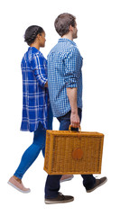  Back view of interracial going couple with a picnic bag.