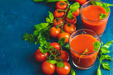 Delicious tomato bloody mary cocktail on dark blue concrete table