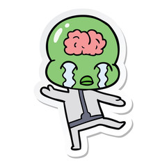 sticker of a cartoon big brain alien crying
