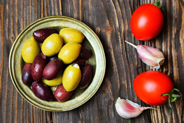 Olives in a bronze plate  on the kitchen table