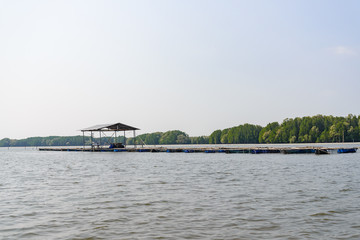 Aquaculture on brackish water at mangrove forest in Chanthaburi, Thailand. Wooden houseboat and oyster, mussel or shell fish farm are built with recycling bottles and background of mangrove forest.