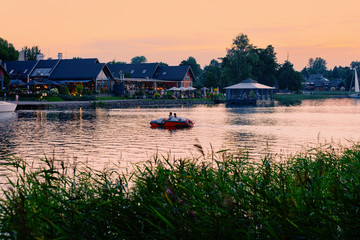 Fototapeta premium Romantic sunset at Street terraced cafe in Galve Lake Trakai