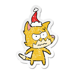 distressed sticker cartoon of a annoyed fox wearing santa hat