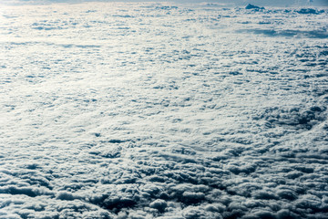 Top view of white clouds above the ground or water