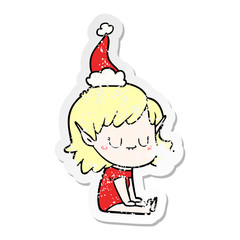 happy distressed sticker cartoon of a elf girl wearing santa hat