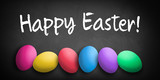 colored eggs with letters forming the word easter on a blackboard