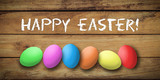 colored eggs with letters forming the word easter on wooden background